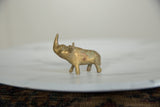 Profile of the handmade bronze rhino showing its aged golden patina.