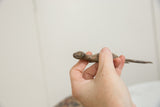 Vintage handmade bronze lizard held to show its collectible scale and character.