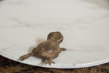 Vintage bronze frog sculpture viewed from behind showing the checkered back.
