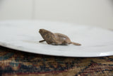 Angled profile view of the vintage African bronze frog's handmade texture.