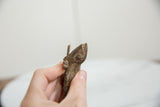 Side profile of the vintage bronze frog showing its handcrafted, textured surface.
