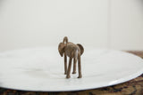 Textured rear view of a handmade African bronze elephant collectible.