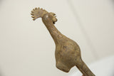 Sculpted texture and aged bronze patina on the lower body of the bird.