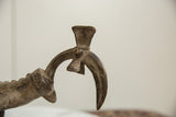 Close-up of the vintage African bronze bird's stylized fan-shaped tail and texture.