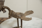Textured body and fanned tail of a vintage African bronze bird showing aged patina.
