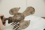 Top-down view of the vintage African bronze bird's textured wings and pronged base.