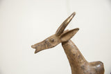 Detailed profile of the vintage African bronze wildebeest's head, ears, and horns.