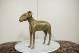 Vintage African bronze ram figure in profile, highlighting its slender form and aged patina.