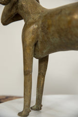 Detail of the vintage bronze ram's textured body and slender hind legs.