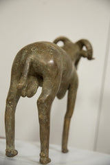 Rear view of the vintage African bronze ram, detailing its hindquarters and aged patina.
