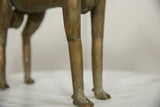 Detailed view of the aged bronze patina on the slender legs and hooves of the ram.