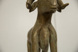 Hand-worked striations and aged patina on the neck and chest of the bronze ram figure.