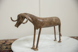 Side view of the vintage African bronze ram, highlighting its slender profile and aged, textured surface.