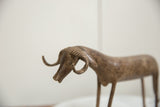 Aged patina and incised texture visible on the curled horns of the vintage African bronze ram's head.