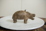 Aged patina and etched texture on a collectible handmade bronze hippo sculpture.