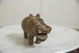 Front view of a vintage bronze hippo's face showing its open mouth and textured surface.