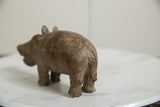 The handmade, textured surface on the rounded back of the vintage African bronze hippo.