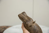 Low-angle view of the vintage bronze hippo, focusing on the handmade texture of its head.