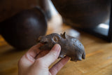 Vintage African bronze hippo held in hand, showing its charming handmade texture.