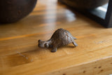 Patina and handmade texture on the vintage African bronze turtle's head and shell.
