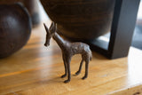 Close-up of the vintage bronze antelope's head and neck, highlighting carved patterns.