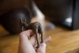 Vintage African bronze antelope sculpture, textured back and aged patina held by hand.