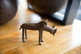 Profile view of a vintage African bronze warthog showing its rustic handmade character.