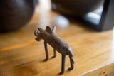Rear angled view of the handmade African bronze warthog's textured body and form.