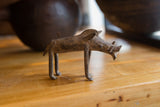Vintage bronze warthog sculpture seen in profile, showing its rustic, handmade texture.