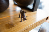 Handmade bronze warthog sculpture with a dark, textured patina.