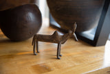 Vintage African bronze zebu collectible displayed on a warm wood tabletop.
