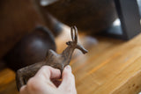 Hand holding the collectible vintage bronze zebu to demonstrate its size.