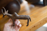 Vintage bronze zebu sculpture held to show its scale and rustic texture.