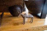 Handmade bronze zebu sculpture with a rich, weathered patina.