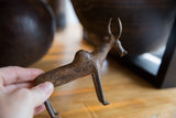 Vintage African bronze zebu held to show its handmade character and aged patina.