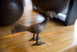 Angled close-up of the handmade texture on the vintage African bronze bird's head and neck.