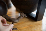 Vintage African Bronze Bird's textured body and webbed foot, held by hand.