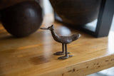 Vintage African bronze flat billed bird with aged patina and handmade texture.