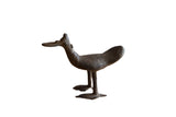 Vintage African bronze bird sculpture with a flat bill and aged, textural finish.