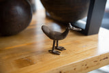 Side profile of the collectible African bronze bird with a matte, textured finish.