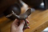 Vintage African bronze bird held in hand, showing its scale and handmade texture.