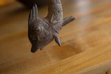 Close-up of the vintage African bronze fish head, showing aged texture.