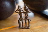 Vintage African bronze figures close-up, showing one covering ears, the other eyes.