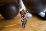 Vintage African bronze figures, highlighting the dark, weathered surface and aged patina.