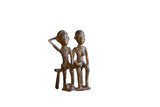 Collectible vintage African bronze figures sitting, dark, with rich patina. Measures 4