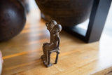 Vintage African bronze figures' handmade faces and rich, time-softened patina.