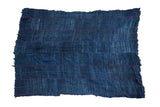 Vintage African indigo handwoven throw, deep blue with subtle vertical stripes and colorful dotted lines.