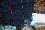 Vintage African indigo throw's distressed bottom edge with colorful hand stitching.