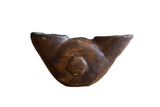 Antique African wooden ceremonial wine cup with a hand-carved face motif and rich, dark patina.
