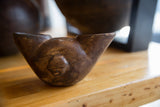 Angled view of the antique African wine cup highlighting its hand-carved form and dark wood patina.